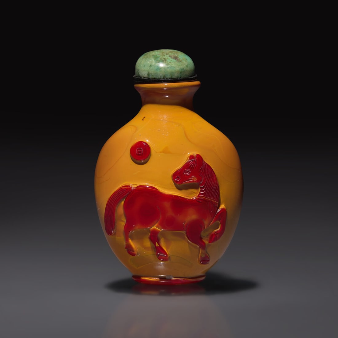 A Chinese Carved "Realgar" Glass "Horse and Lion" Snuff Bottle, Qing Dynasty, 19th Century: A Chinese Carved "Realgar" Glass "Horse and Lion" Snuff Bottle, Qing Dynasty, 19th Century 清晚期 仿雄黃地套紅料動物圖(