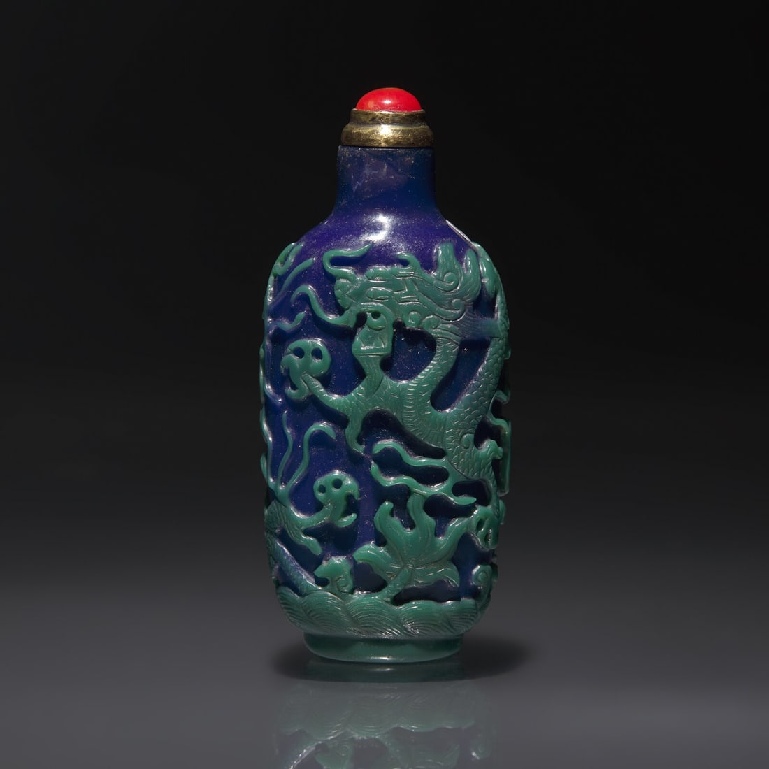 A Chinese Overlay Glass "Three Dragons" Snuff Bottle, Qing Dynasty, 19th century (1 of 2)