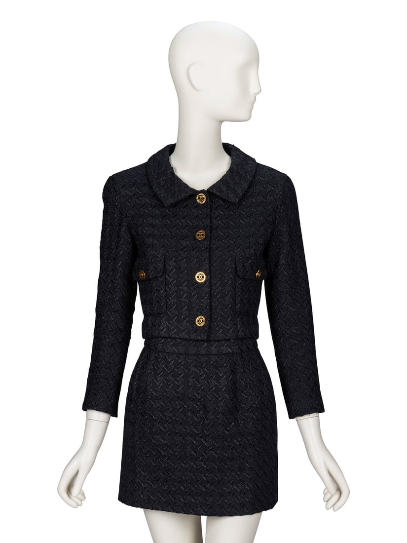 Chanel, Black Jacquard Skirt Suit: Chanel, Black Jacquard Skirt Suit JACKET Cropped jacket in textured black jacquard tweed. Spread collar. Light padding at shoulders. Bracelet-length set-in sleeves with working button closures at