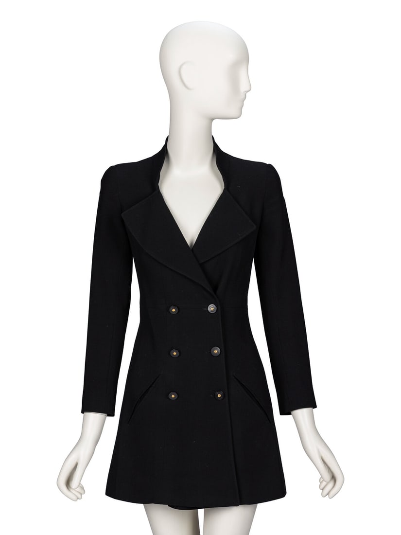 Chanel, Black Blazer Minidress: Chanel, Black Blazer Minidress Blazer-style minidress in black serge. Stand collar, wide lapels, and V neckline. Padding at shoulders. Wrist-length sleeves with working button closures at cuffs. Two