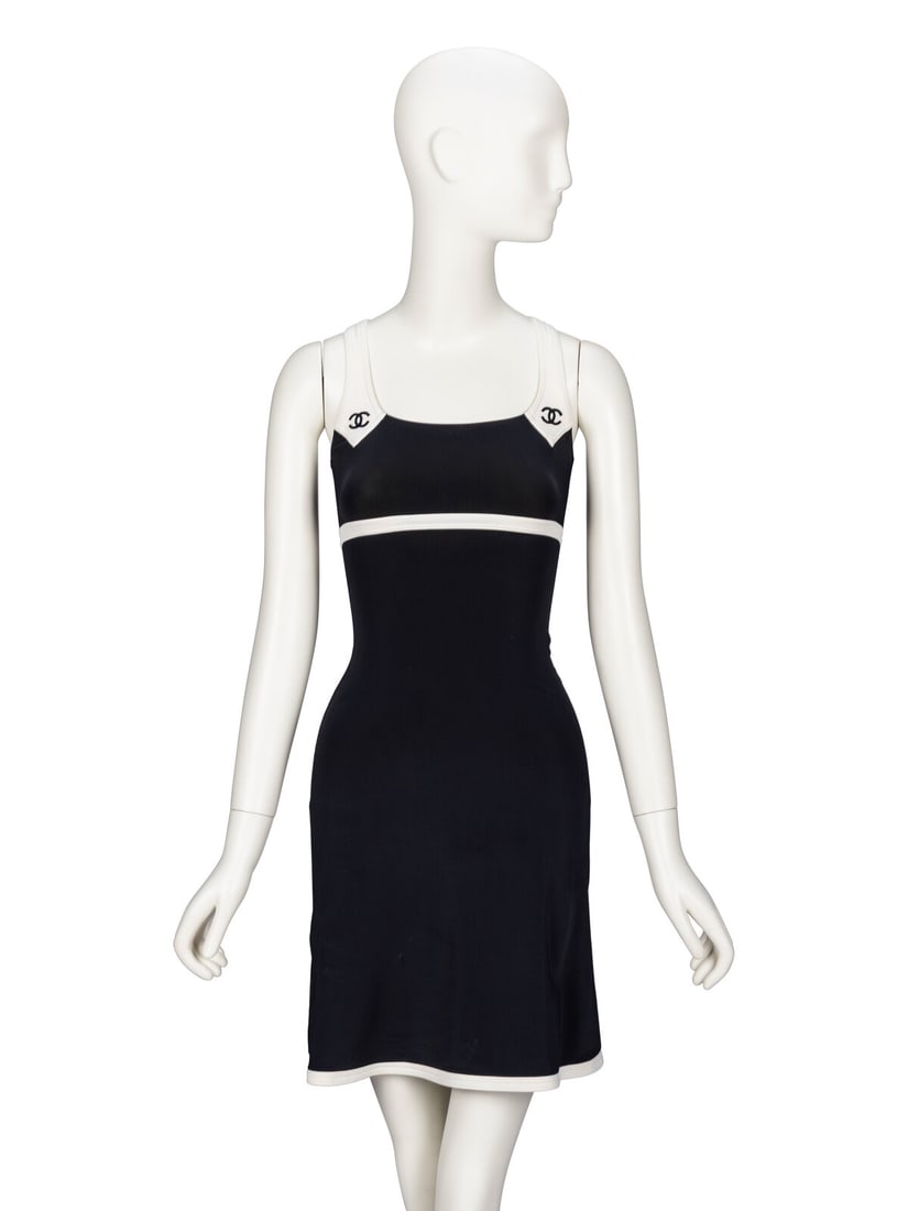 Chanel, Black & White Dress: Chanel, Black & White Dress Sleeveless dress in black & white stretch-blend nylon knit. White straps with CC embroideries; racer-back style. Fitted bodice and knee-length A-line skirt. No closures.