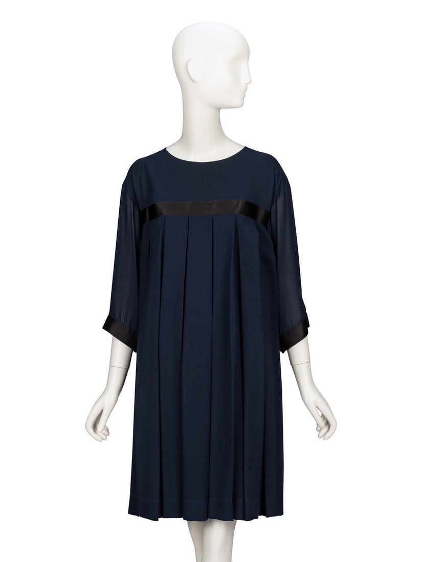 Chanel, Chiffon Babydoll Dress: Chanel, Chiffon Babydoll Dress Babydoll dress in navy silk chiffon with black satin ribbon trim throughout. Round, wide collarless neckline. Elbow-length wide sleeves. High empire waistline. Wide