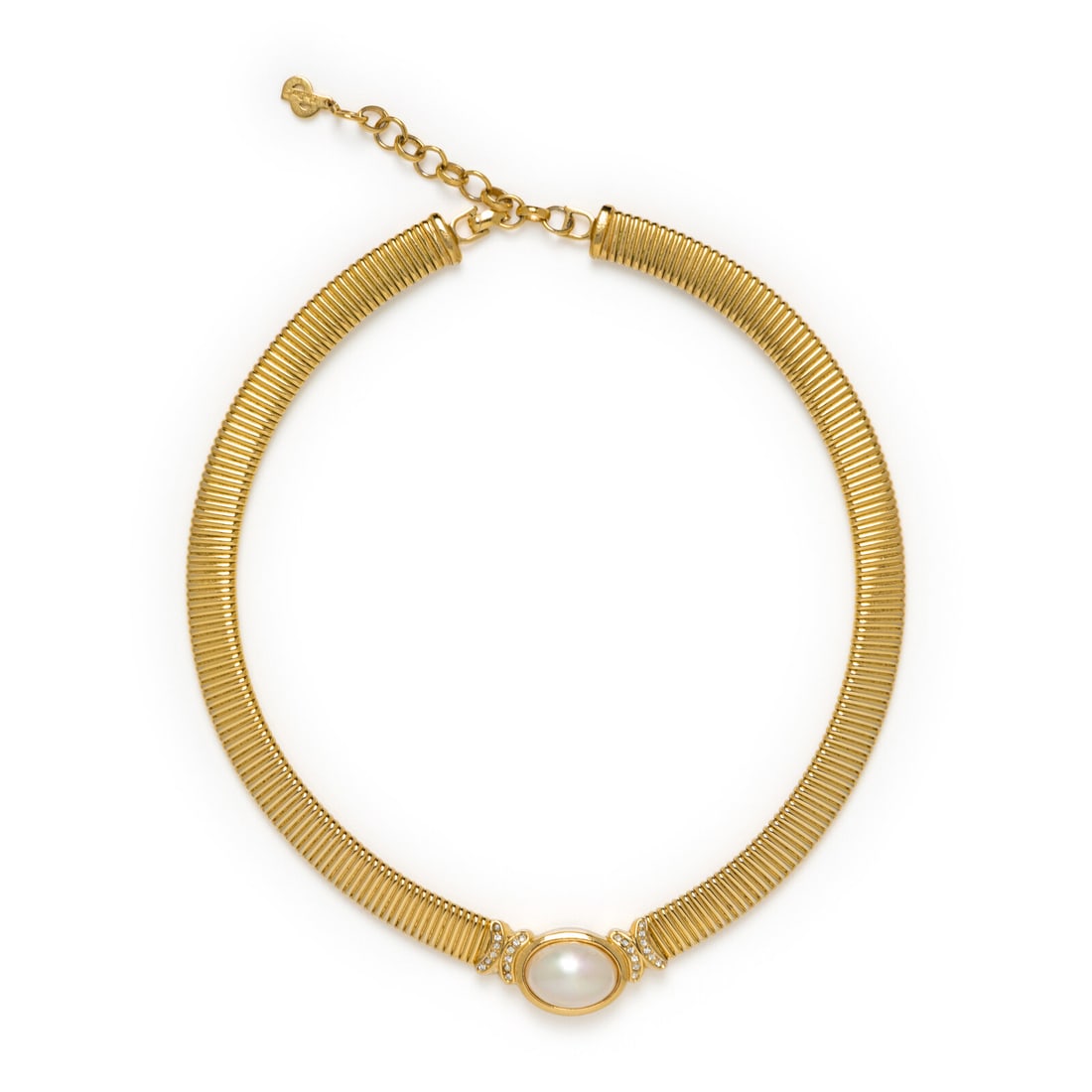 Christian Dior, Omega Necklace, 1980s: Christian Dior, Omega Necklace, 1980s "Omega" necklace in gold-tone metal with rhinestones and a simulated half pearl. Fold-over clasp closure with chain extender. Stamped at hanging tag and clasp.