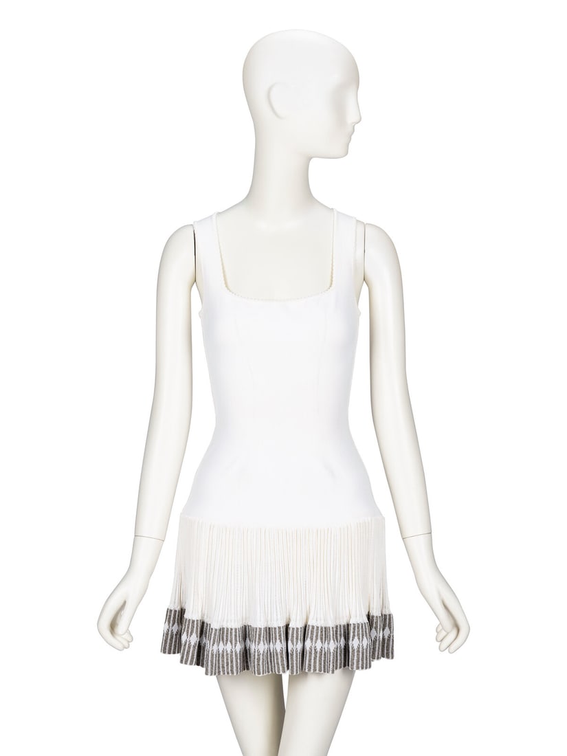 Ala‘a, Sleeveless Knit Minidress: AlaÔa, Sleeveless Knit Minidress Sleeveless fitted minidress in white viscose knit. Scoop neckline with scalloped trim at edges. Fitted bodice. Drop waistline with a ribbed open-knit grey & ecru