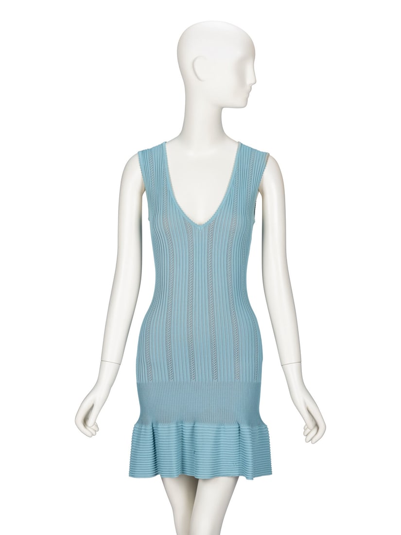 Ala‘a, Blue Knit Minidress: AlaÔa, Blue Knit Minidress Fitted sleeveless minidress in sky blue ribbed pointelle knit viscose. Deep V neckline. Fitted bodice. Drop waist silhouette with flared short skirt. Invisible zipper
