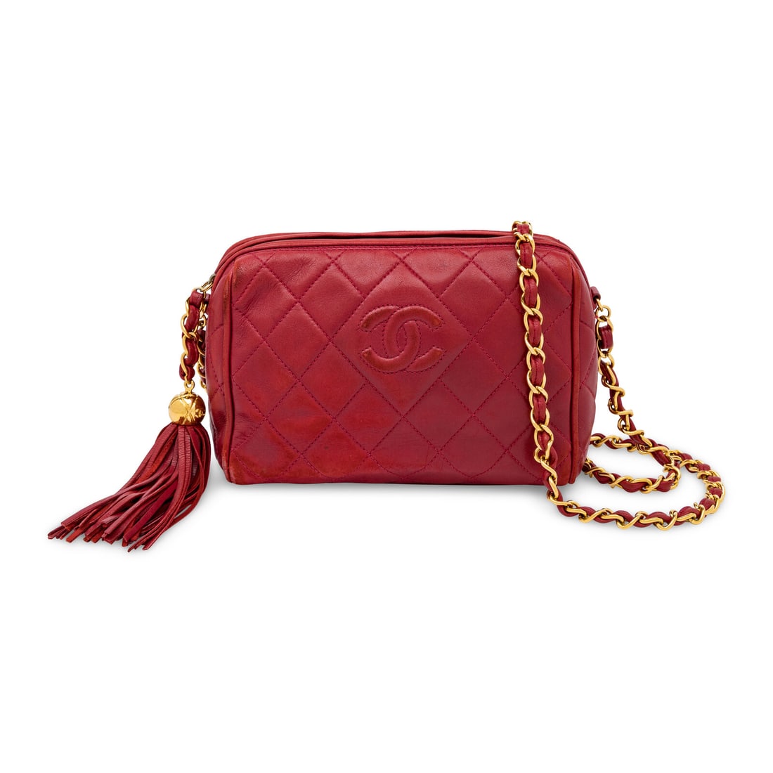 Chanel, Camera Bag in Quilted Red Leather: Chanel, Camera Bag in Quilted Red Leather Camera bag in quilted red lambskin leather with gold-tone hardware. Zipper closure, tasseled leather zipper pull, and interwoven leather-metal chain strap.