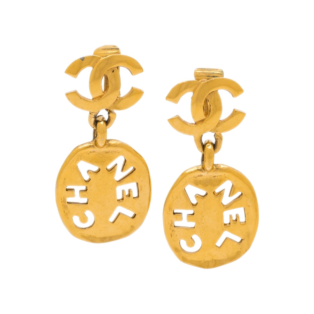 Chanel, CC Logo Ear Clips: Chanel, CC Logo Ear Clips Pair of ear clips in gold-tone metal with CCs and a dangling oval charm with "CHANEL" cutouts. Label: Chanel Date: 1980's Country of Origin: Unmarked, likely France