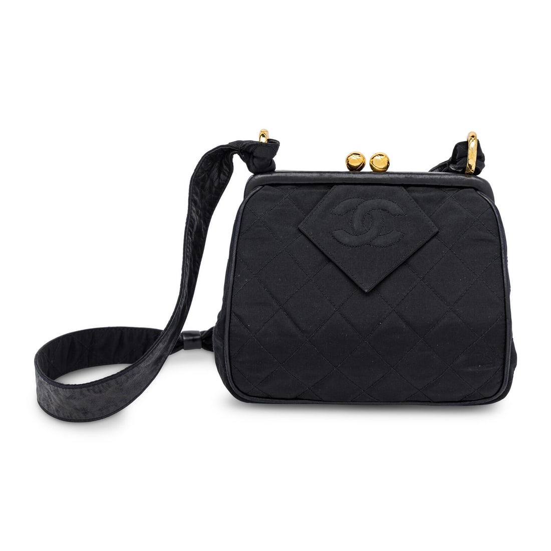 Chanel, Kiss Lock Shoulder Bag in Quilted Black Taffeta: Chanel, Kiss Lock Shoulder Bag in Quilted Black Taffeta Shoulder bag in quilted black taffeta with black leather trim and gold-tone hardware. Kiss lock closure to frame top and leather and taffeta fla