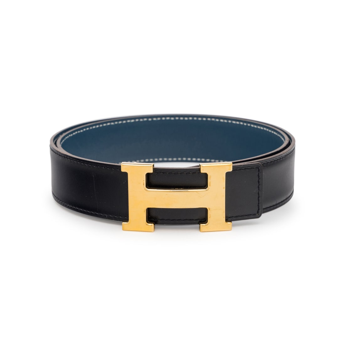 Hermès, Black/Blue Reversible Constance Belt: Hermès, Black/Blue Reversible Constance Belt Reversible Constance belt in black and blue leather with a gold-plated H buckle. Label: Hermès Stamp: H in Square Size: 80 Date: 2004 Country of Origin: