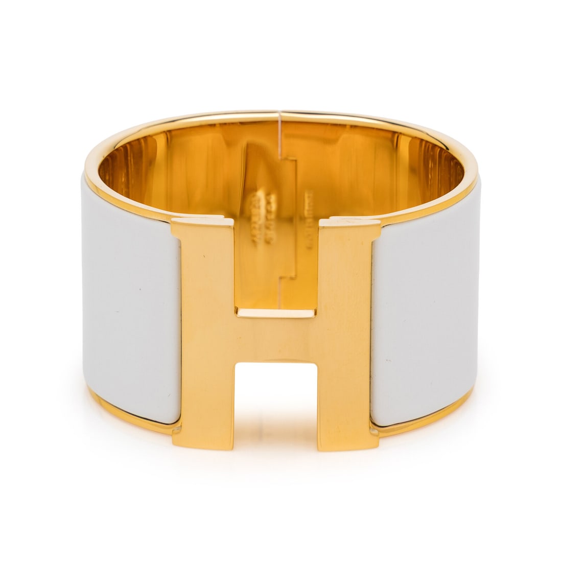 Hermès, Extra Wide Clic Clac H Bracelet: Hermès, Extra Wide Clic Clac H Bracelet Extra wide Clic Clac H bracelet in gold-tone metal with white enamel details. Turn-lock H closure. Label: Hermès Country of Origin: France Approximate