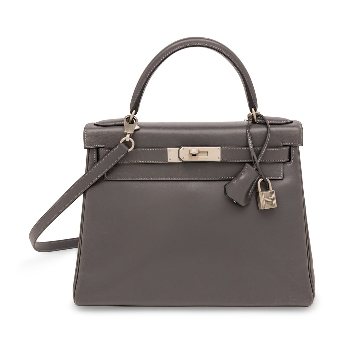 Hermès, Kelly 28 in Ardoise Box: Hermès, Kelly 28 in Ardoise Box Kelly 28 Retourne in grey Ardoise Box leather with brushed palladium-plated hardware. Label: Hermès Stamp: C in Square Date: 1999 Country of Origin: France
