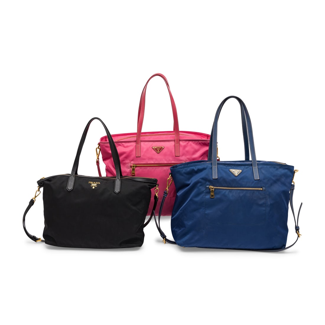 Prada, Three Nylon Totes: Prada, Three Nylon Totes THE FIRST Tote bag in black nylon with black saffiano leather trim and gold-tone metal hardware. Zipper closure, flat leather handles, and removable flat leather strap.