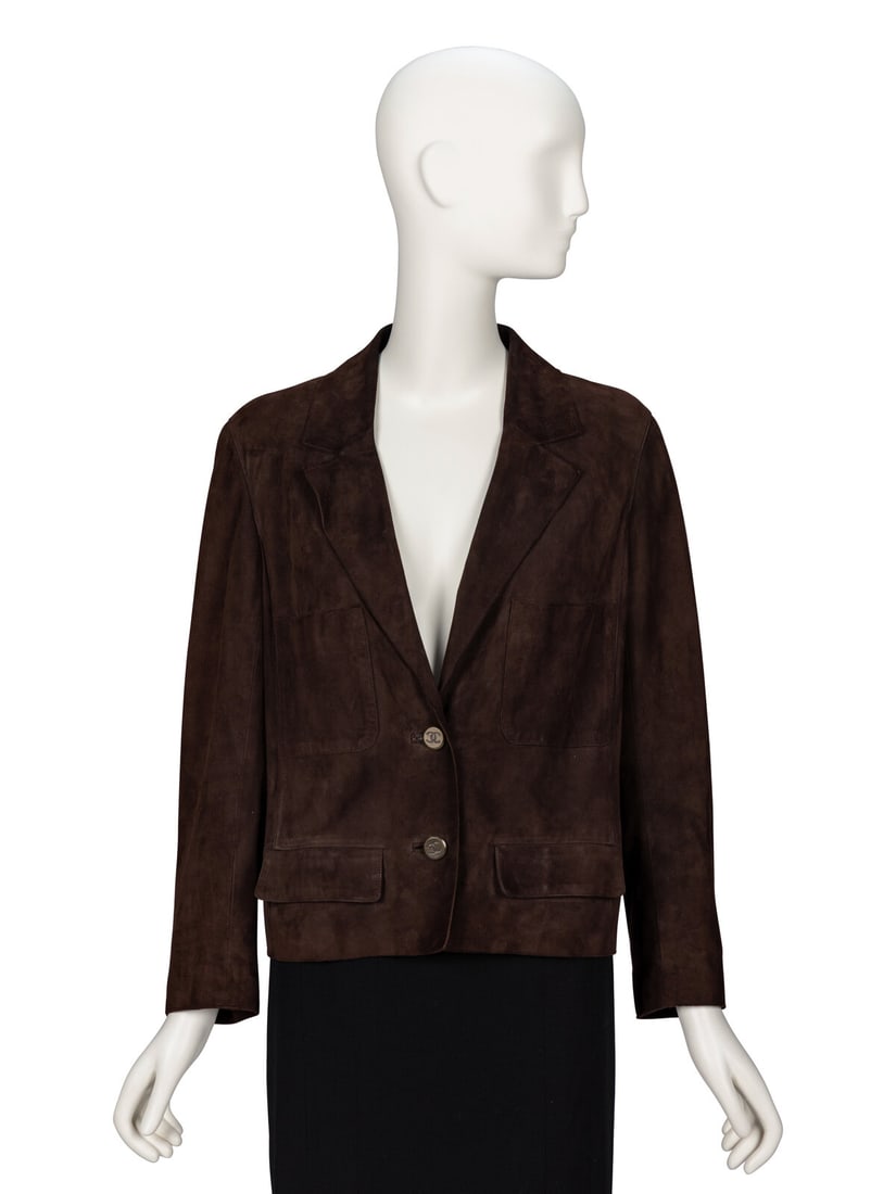 Chanel, Chocolate Brown Suede Jacket: Chanel, Chocolate Brown Suede Jacket Boxy jacket in chocolate brown lambskin suede. Slightly cropped bodice length. Notched lapels. Light padding at shoulders. Full-length sleeves with single button c