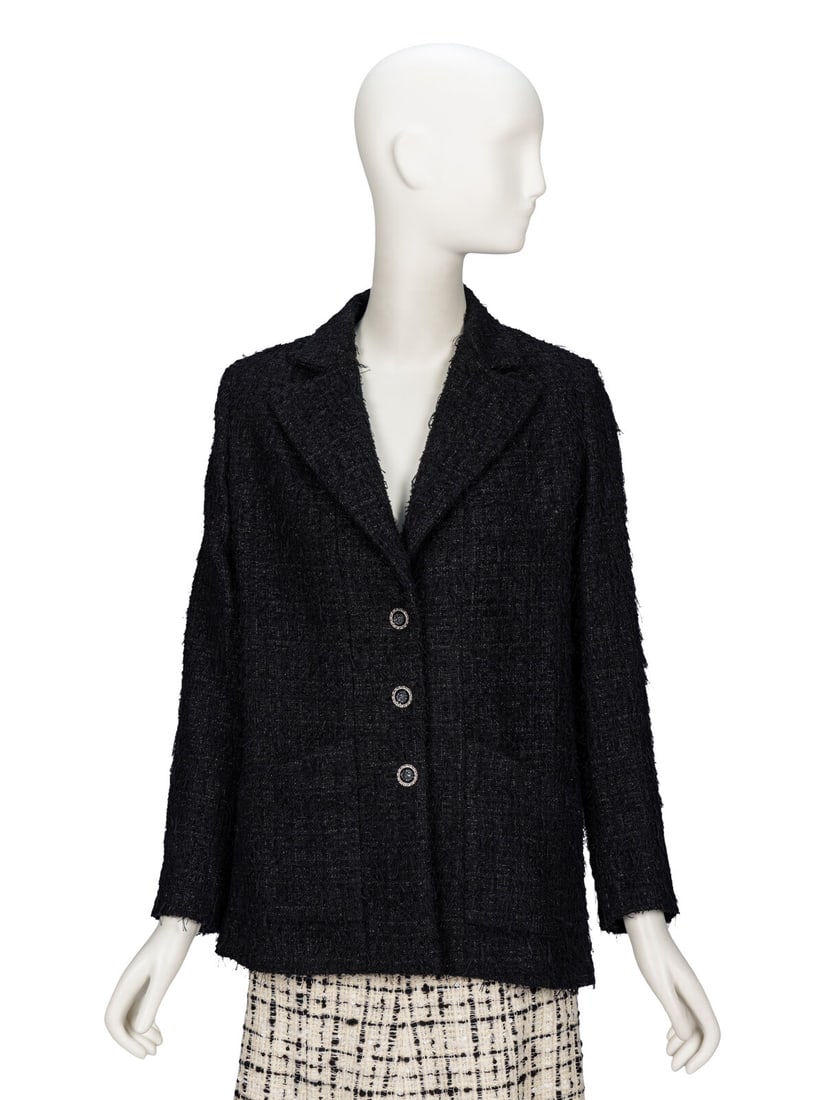 Chanel, Fringed Glittery Tweed Blazer: Chanel, Fringed Glittery Tweed Blazer Tailored blazer in fringed glittery black cotton-blend tweed. Notched lapels. Light padding at shoulders. Full-length set-in sleeves with working button closures