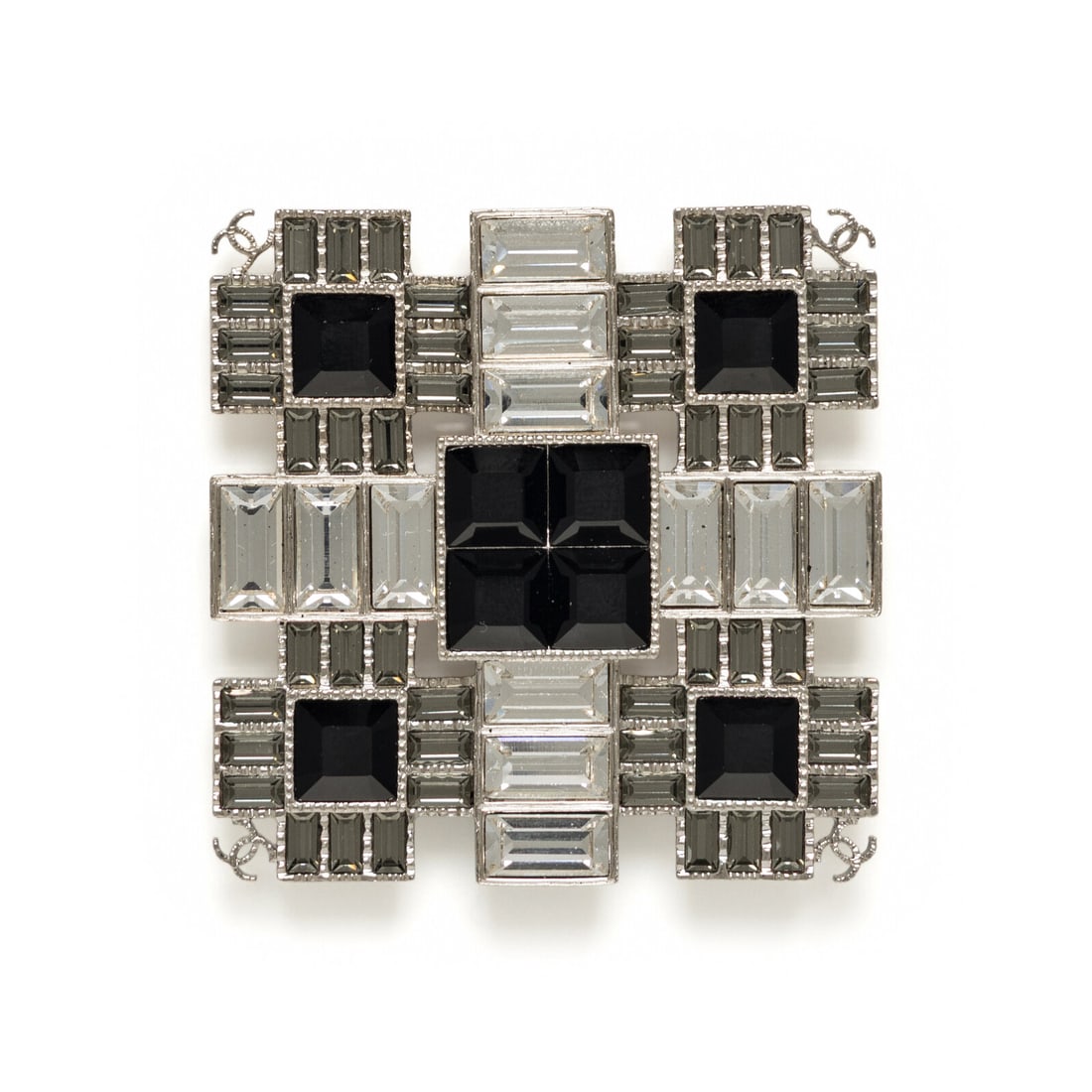 Chanel, Geometric Rhinestone Brooch: Chanel, Geometric Rhinestone Brooch Geometric square brooch in silver-tone metal with black, grey and clear rhinestone settings throughout. Standard pin back. Includes box. Label: Chanel Date: 2019