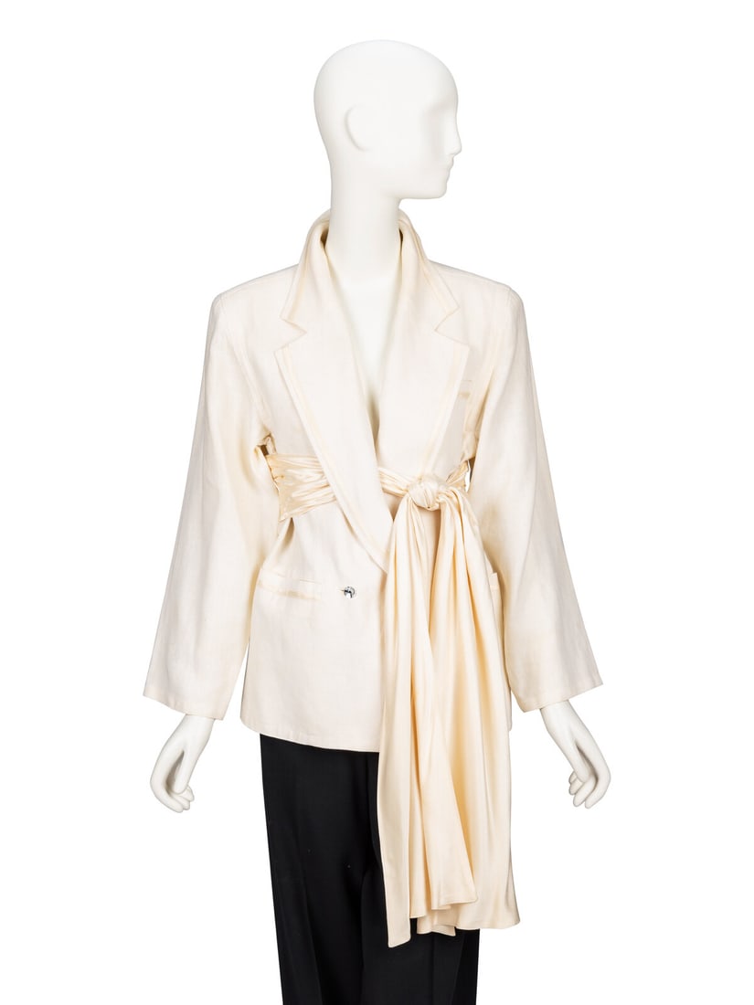 Gianni Versace, Ecru Linen Draped Blazer with Satin Tie: Gianni Versace, Ecru Linen Draped Blazer with Satin Tie Tailored blazer in ecru linen with tonal silk charmeuse trim. Features an attached pleated & draped charmeuse tie sash at waist. Wide notched