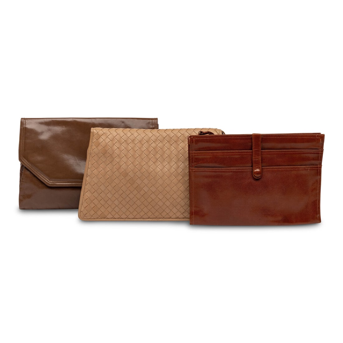 Bottega Veneta, Three Leather Clutches: Bottega Veneta, Three Leather Clutches THE FIRST Envelope clutch in glossy brown leather. Label: Bottega Veneta Date: Late 20th Century Country of Origin: Italy Approximate Measurements: 12.25ì