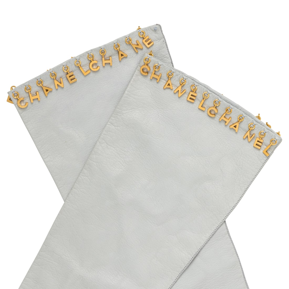 Chanel, Kidskin Letter Charm Gloves: Chanel, Kidskin Letter Charm Gloves Elbow-length gloves in powder blue kidskin with "CHANEL" letter charms at end in gold-tone metal. No closures; unlined. Label: Chanel Size: 7.5 Date: Late 20th