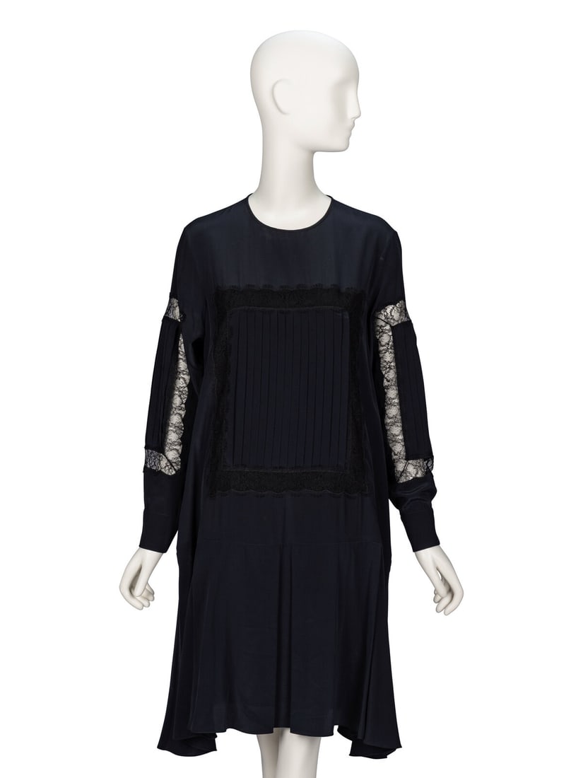 Rochas, Black Silk Shift Dress: Rochas, Black Silk Shift Dress Knee-length shift dress in black silk crÍpe de chine with black lace appliques throughout. Round collarless neckline. Full-length set-in sleeves with buttoned
