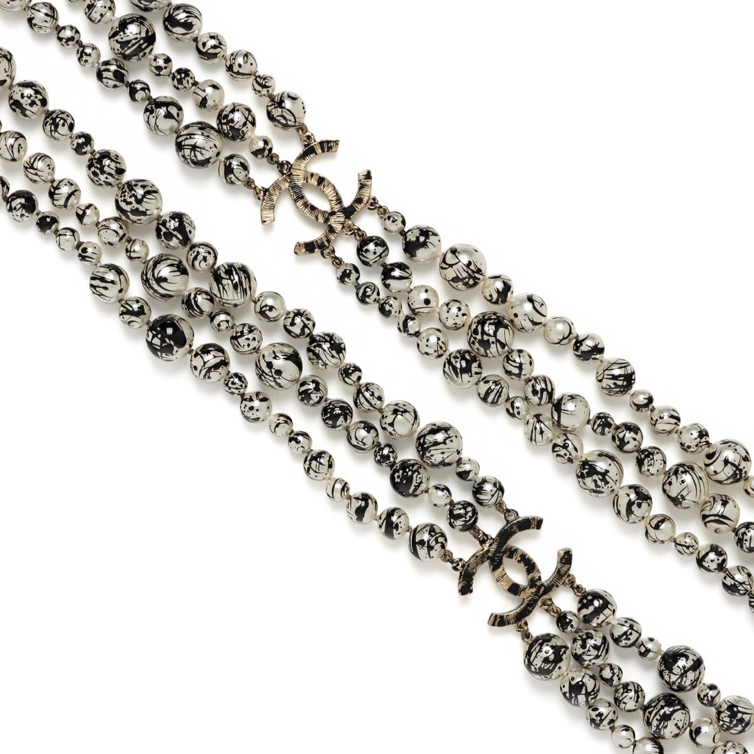 Chanel, Paint-Splattered Pearl Sautoir, 2013: Chanel, Paint-Splattered Pearl Sautoir, 2013 Triple-strand layered sautoir necklace in white Gripoix pearl beads with black paint splatters and gold-tone metal hardware. Lobster clasp closure. Label: