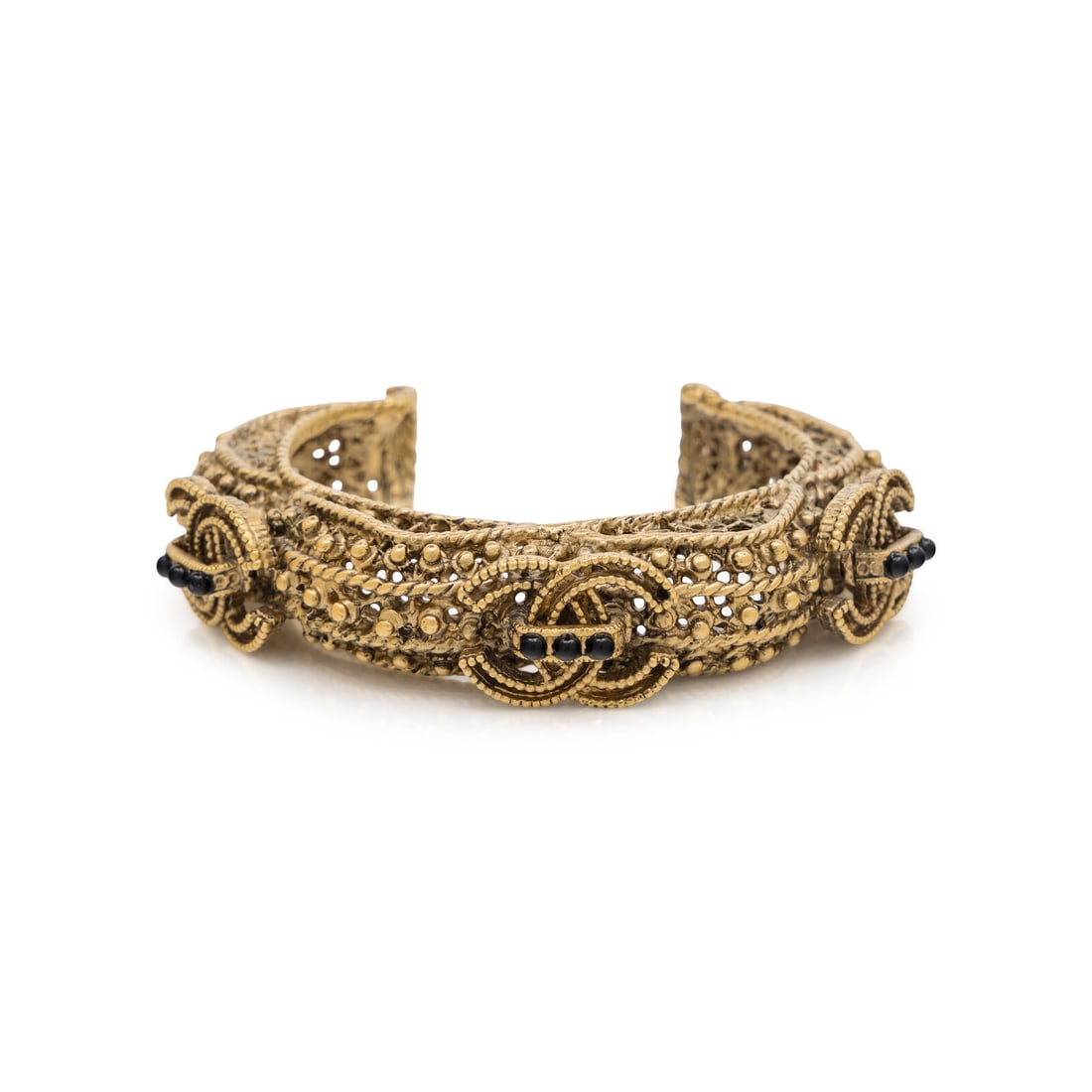 Chanel, Ornate Gilt Cuff: Chanel, Ornate Gilt Cuff Open cuff bracelet in ornate openwork gold-tone metal with black bead embellishments. Label: Chanel Date: F/W 2011 Country of Origin: France Approximate Measurements: Inner