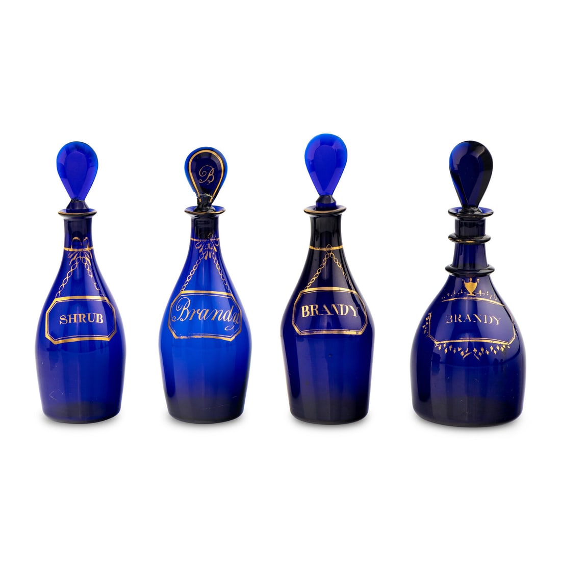 A Group of Four Cobalt Glass and Gilt Decorated Decanters: A Group of Four Cobalt Glass and Gilt Decorated Decanters 19th Century Height 10 inches. Property from the Collection of Patricia and Michael Corbett, Kenilworth, Illinois This lot is located in Chica