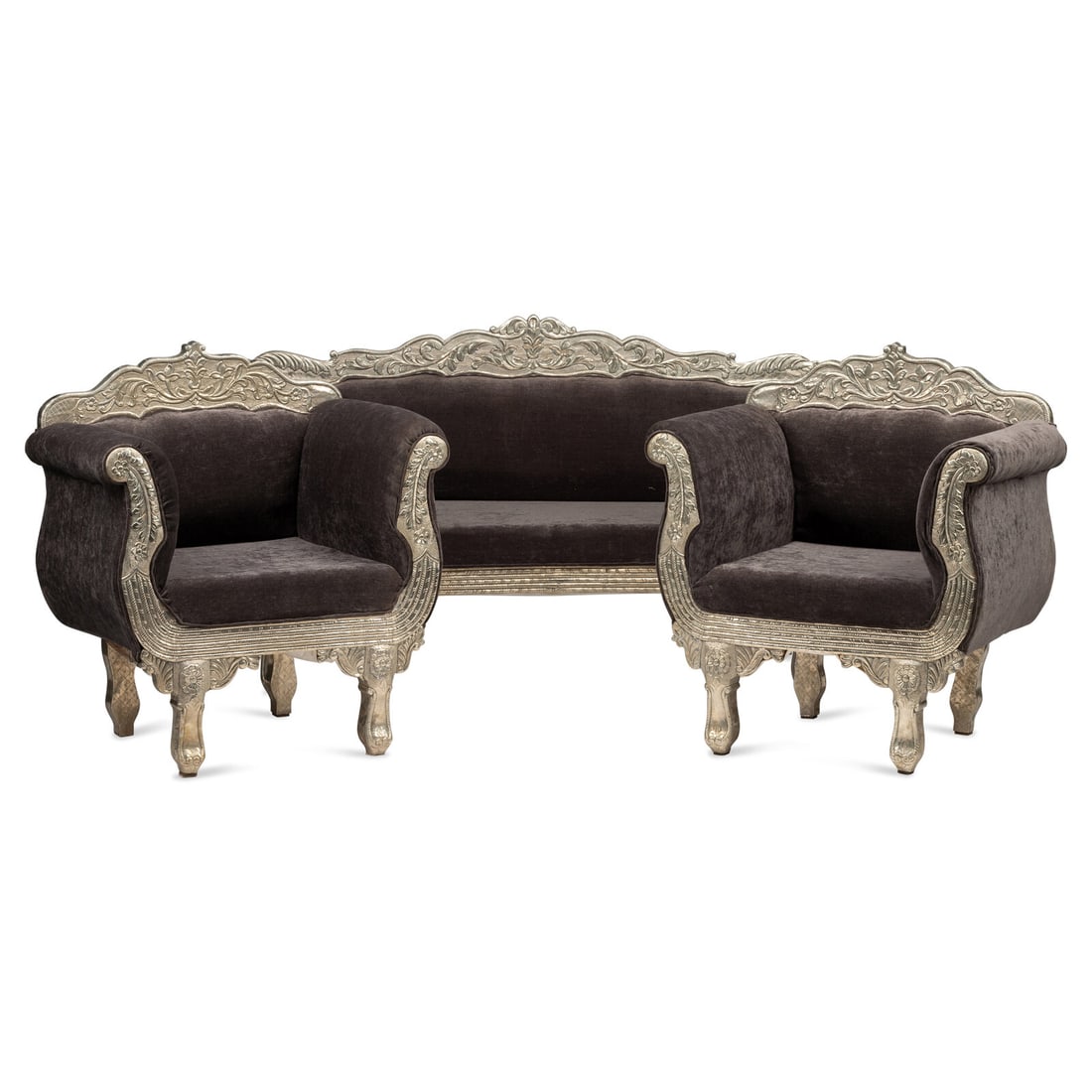 An Anglo-Indian Silvered Metal Repoussé Seating Suite: An Anglo-Indian Silvered Metal Repoussé Seating Suite 20th Century Height of settee 41 x width 76 x depth 23 1/2 inches; Height of chairs 40 1/2 x width 36 x depth 23 1/2 inches. This lot is loca
