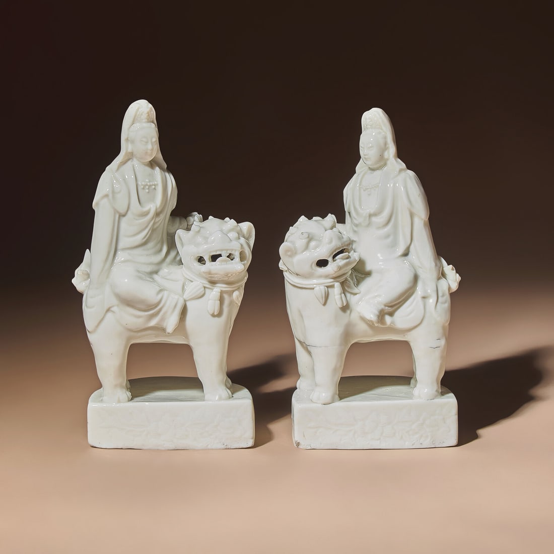 A Matched Pair of Chinese Blanc-de-Chine Figural Groups of Bodhisattva Manjushri Sitting on Fu Lion,: A Matched Pair of Chinese Blanc-de-Chine Figural Groups of Bodhisattva Manjushri Sitting on Fu Lion, Late 17th Century 清早期 德化白瓷文殊菩