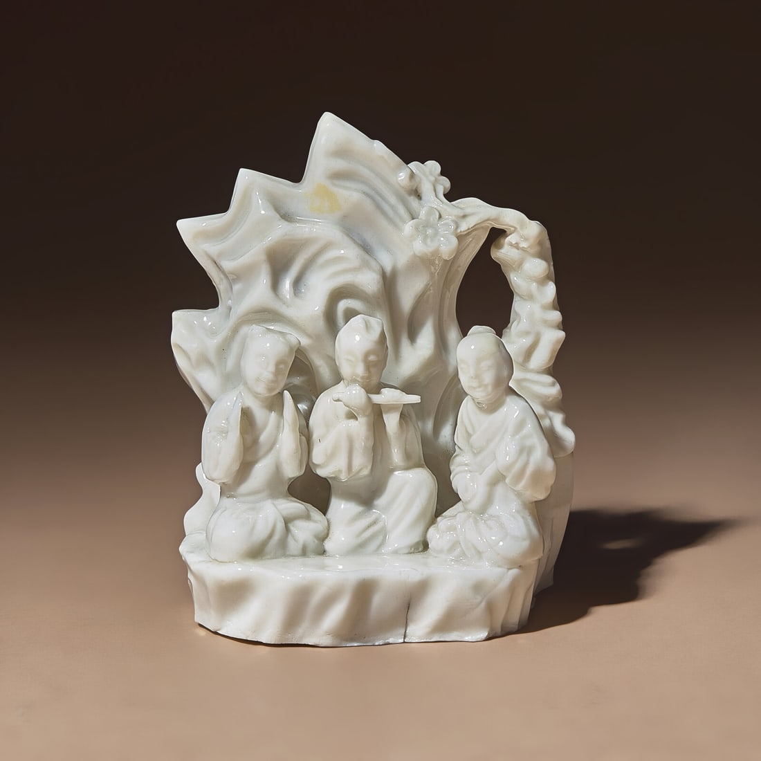 A Chinese Blanc-de-Chine Porcelain Figural Group of Three Musicians, 18th Century: A Chinese Blanc-de-Chine Porcelain Figural Group of Three Musicians, 18th Century 清中期 德化白瓷塑吹奏圖山子 18th Century