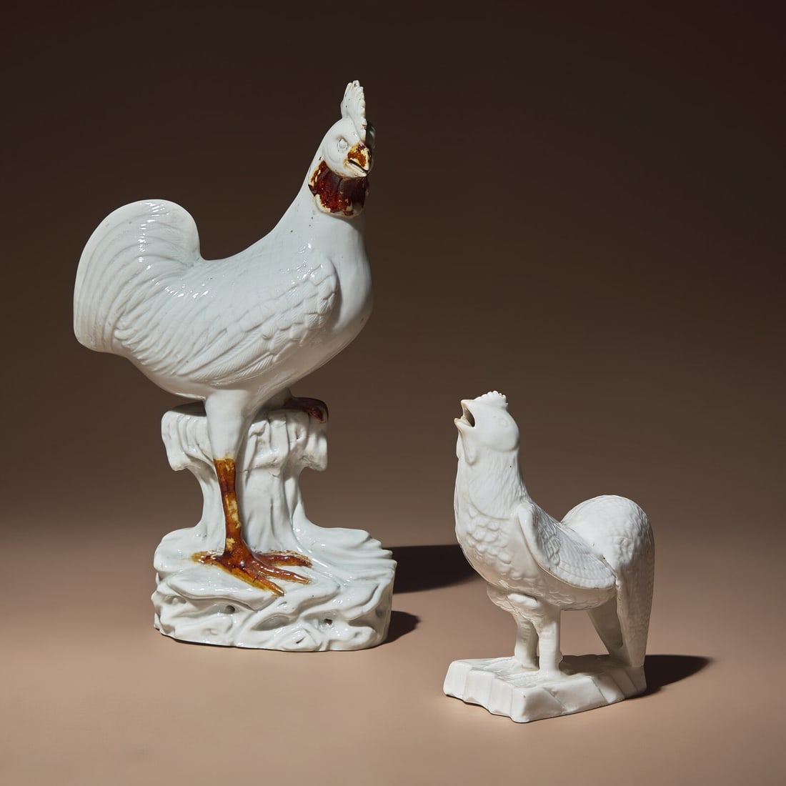 Two Chinese Blanc-de-Chine Porcelain Figures of Cockerels, 18th/19th Century: Two Chinese Blanc-de-Chine Porcelain Figures of Cockerels, 18th/19th Century 清中期 德化白瓷雄鷄兩隻 18th/19th Century Each figure mod