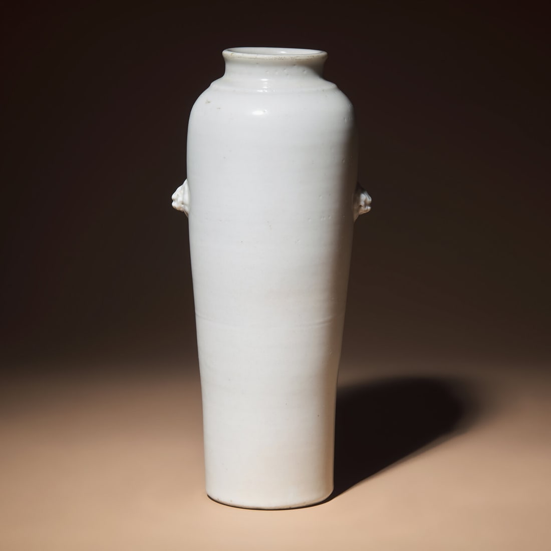 A Chinese Blanc-de-Chine Porcelain Sleeve Vase, Early Qing Dynasty: A Chinese Blanc-de-Chine Porcelain Sleeve Vase, Early Qing Dynasty 清早期 德化白瓷雙獸首筒瓶 Early Qing Dynasty Of attenuated ta