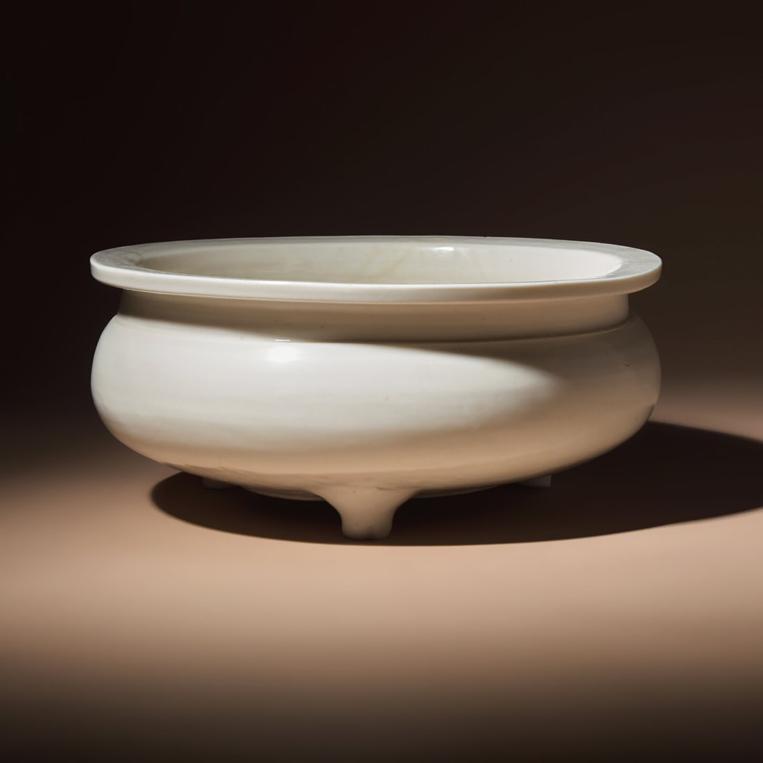 A Large Chinese Blanc-de-Chine Porcelain Incense Burner, Early Qing Dynasty: A Large Chinese Blanc-de-Chine Porcelain Incense Burner, Early Qing Dynasty 清早期 德化白瓷大三足爐 Early Qing Dynasty The undecorated