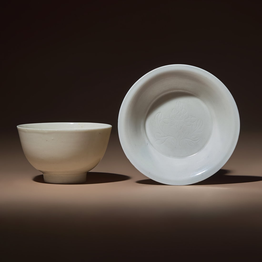 A Chinese Blanc-de-Chine Porcelain Bowl and an Incised 'Peony' Shallow Dish, Ming-Qing Dynasty: A Chinese Blanc-de-Chine Porcelain Bowl and an Incised 'Peony' Shallow Dish, Ming-Qing Dynasty 明-清 德化白瓷碗及暗刻牡丹紋