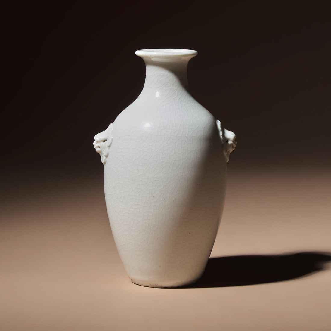 A Chinese Blanc-de-Chine Porcelain Baluster Vase, Qing Dynasty: A Chinese Blanc-de-Chine Porcelain Baluster Vase, Qing Dynasty 清 德化白瓷雙輔首耳瓶 Qing Dynasty (1644-1911) The ovoid body rises to a slig