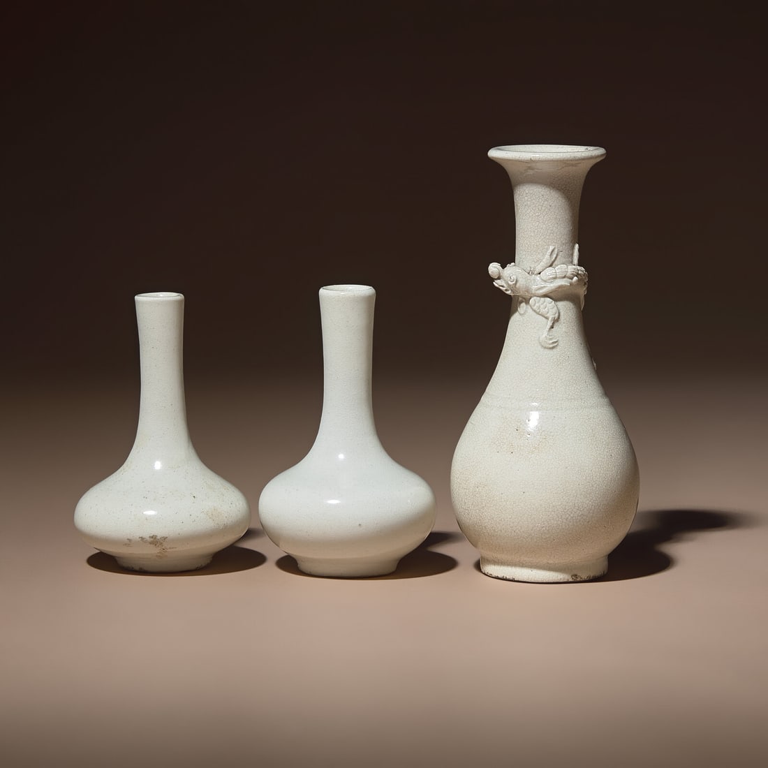 Three Small Chinese White Glazed Porcelain Bottle Vases, Qing Dynasty: Three Small Chinese White Glazed Porcelain Bottle Vases, Qing Dynasty 清 白瓷瓶三件 Qing Dynasty (1644-1911) The first a pear-shaped vase rising from a straight cir