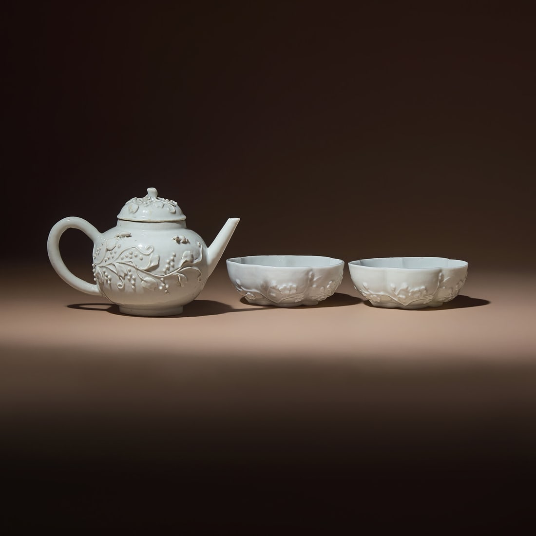 A Chinese Blanc-de-Chine Molded Porcelain Covered Teapot and a Pair of Molded Floriform Bowls, 18th (1 of 3)