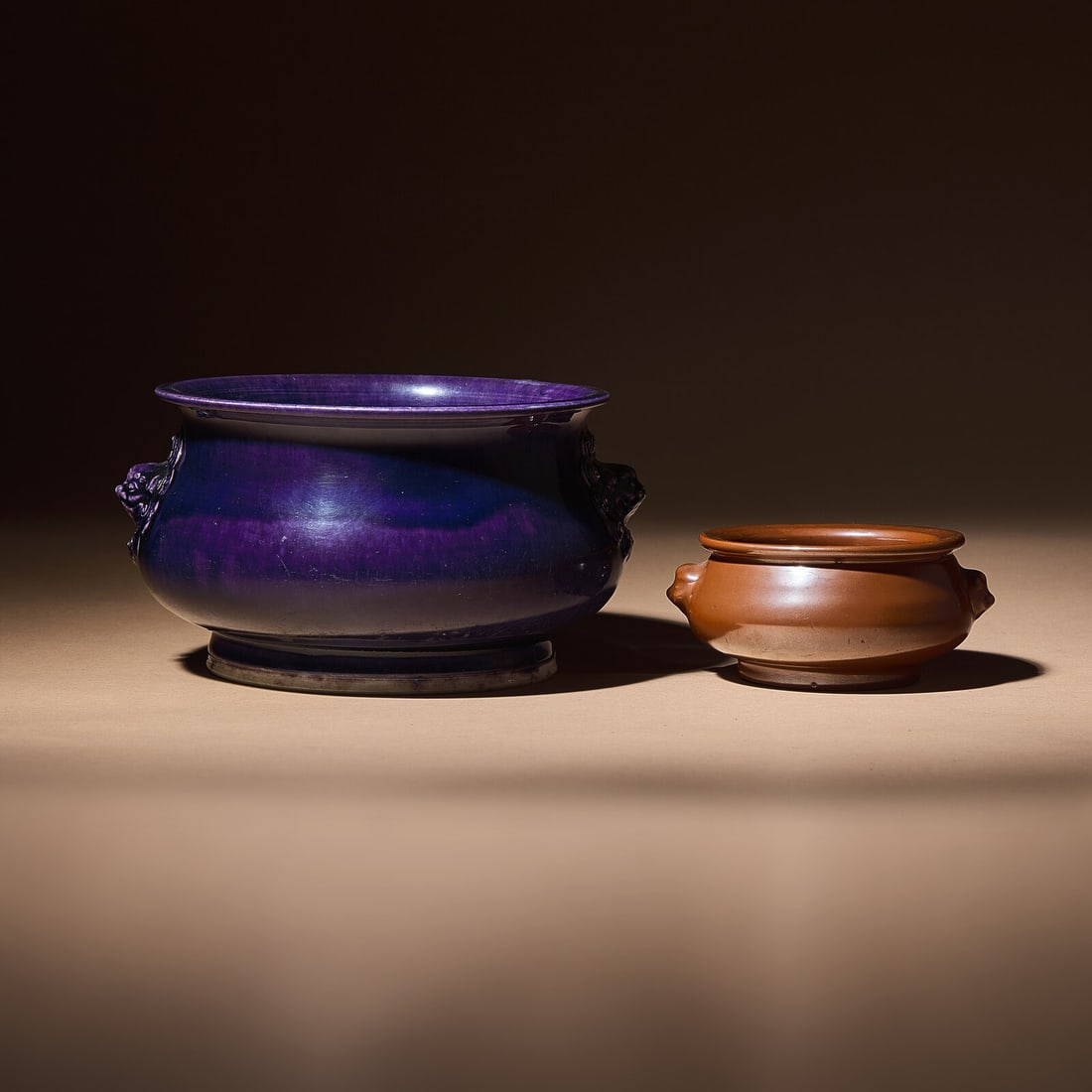 Two Chinese Monochrome Glazed Porcelain Censers, 17th-18th Century: Two Chinese Monochrome Glazed Porcelain Censers, 17th-18th Century 清早中期 紫金釉及藍釉獅耳爐兩具 17th-18th C
