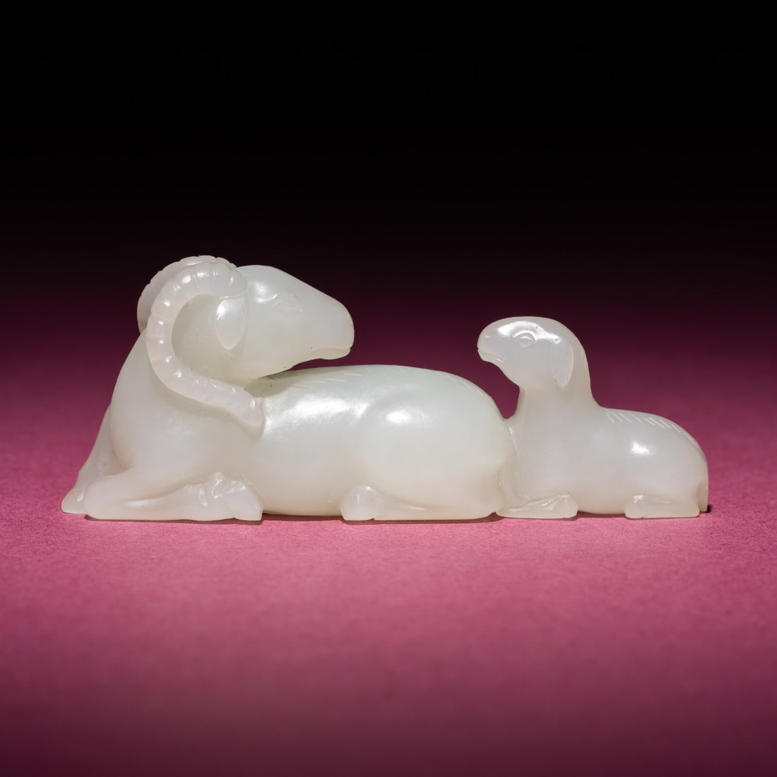 A Chinese White Jade 'Rams' Group, 18th/19th Century: A Chinese White Jade 'Rams' Group, 18th/19th Century 清中期 白玉雙羊把件 18th/19th Century Intricately carved as a recumbent ram with all four leg