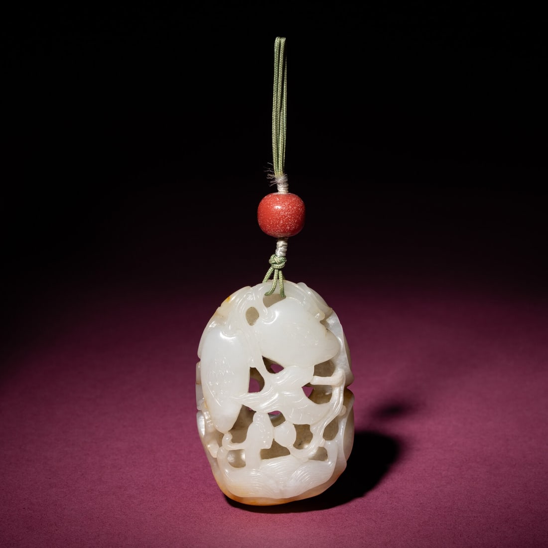 A Chinese Russet and White Jade Reticulated Pendant, 18th/19th Century: A Chinese Russet and White Jade Reticulated Pendant, 18th/19th Century 清中期 白玉帶皮鏤雕石榴荔枝佩 18th/19th Centu