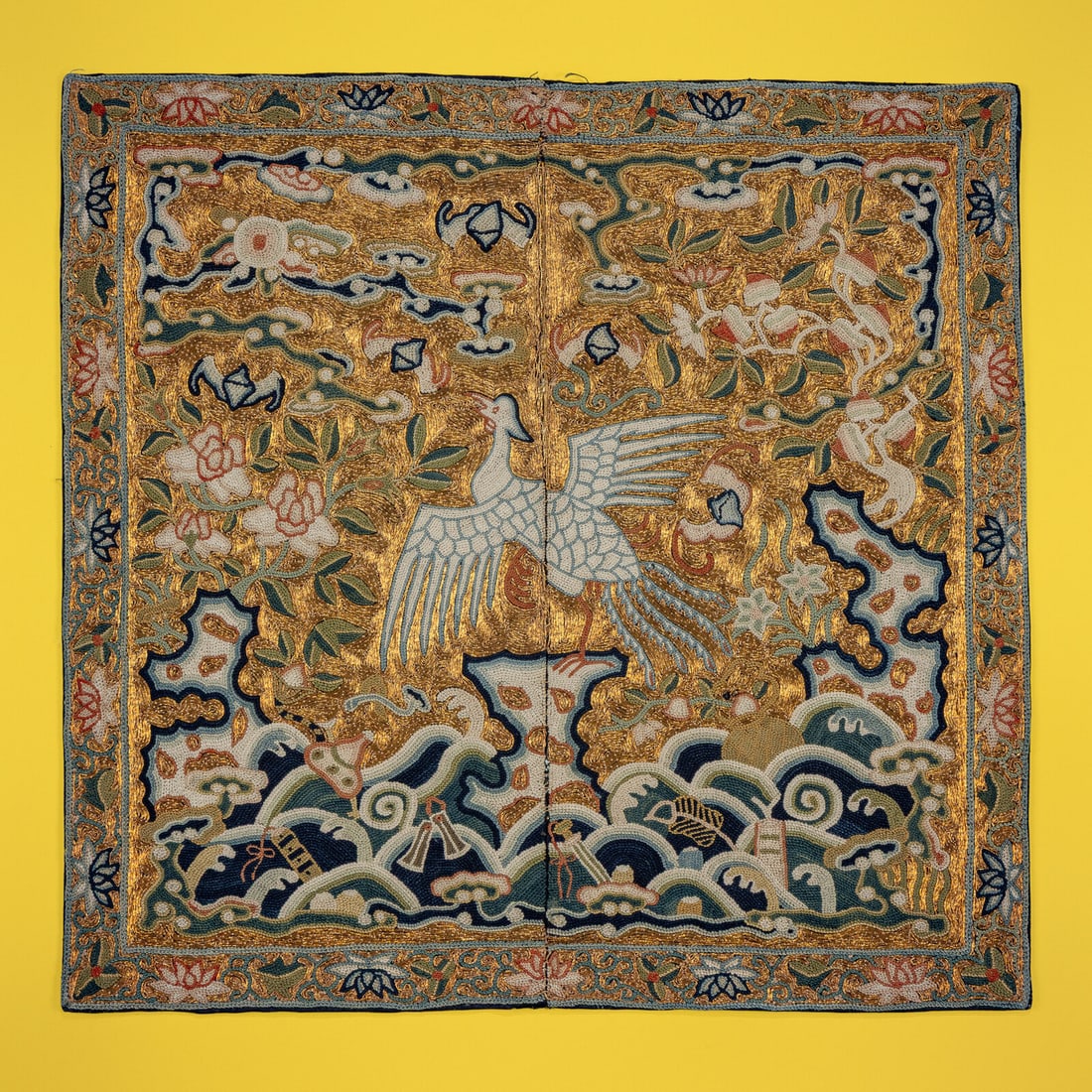 A Chinese Embroidered Gold Ground 'Silver Pheasant' Rank Badge, Jiaqing Period: A Chinese Embroidered Gold Ground 'Silver Pheasant' Rank Badge, Jiaqing Period 清嘉慶 盤金綉五品文官白鷳補子 Jiaqing