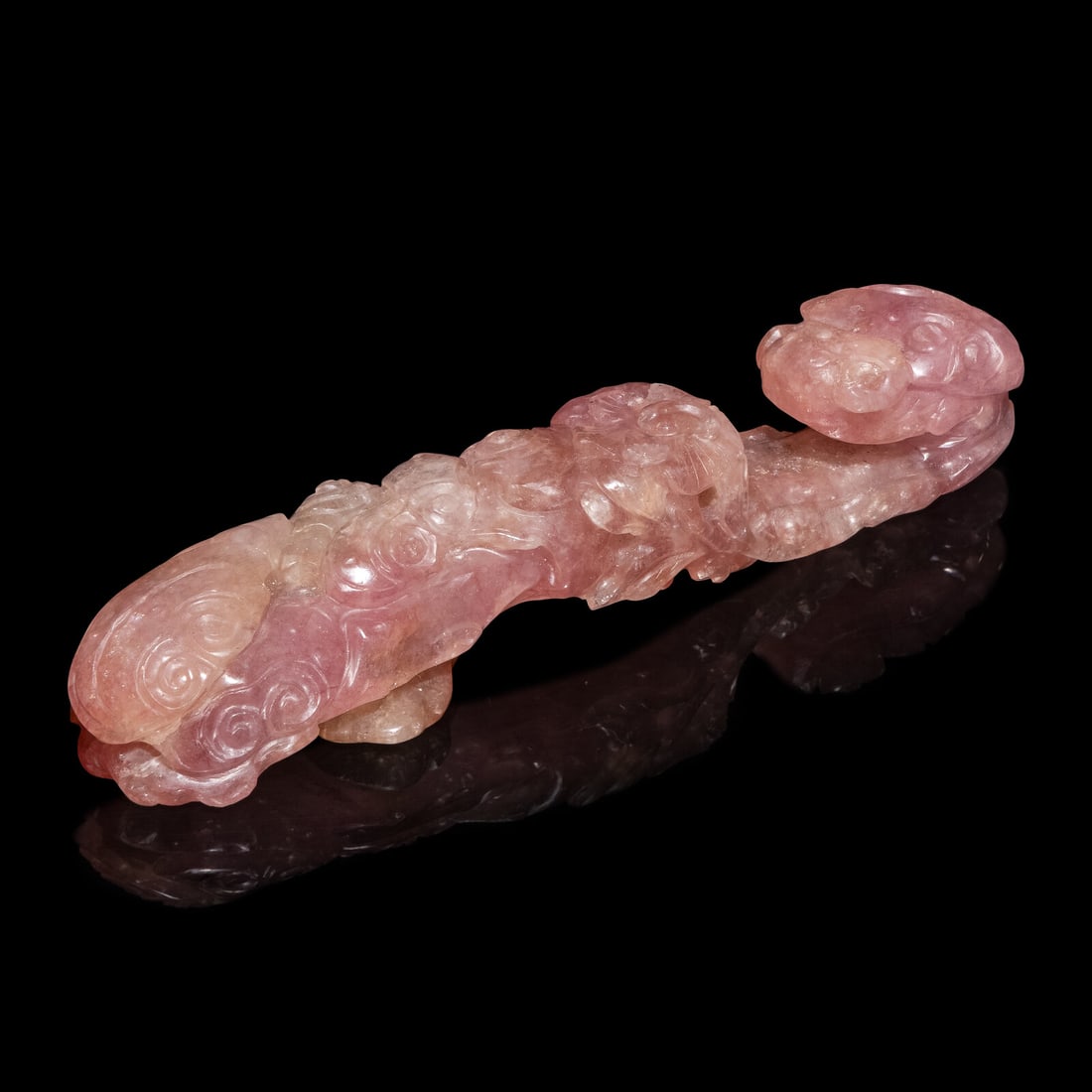 A Chinese Pink Tourmaline 'Dragon and Lingzhi' Belt Hook, 19th Century: A Chinese Pink Tourmaline 'Dragon and Lingzhi' Belt Hook, 19th Century 清晚期 碧璽螭龍帶鈎 19th Century The terminal of the belt hook carved as a 