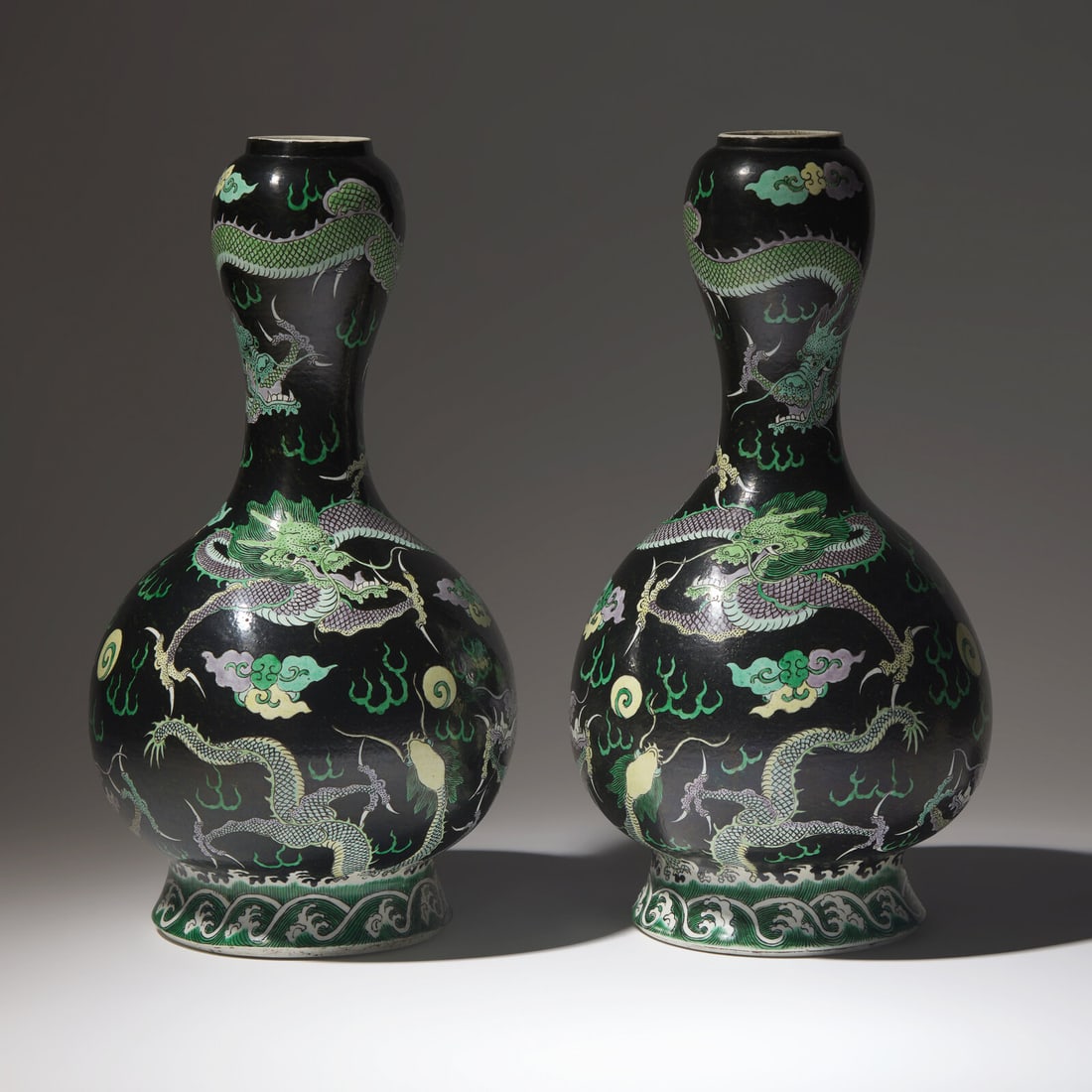 A Pair of Famille Noir 'Dragon' Garlic Head Vases, Late 19th/Early 20th Century: A Pair of Famille Noir 'Dragon' Garlic Head Vases, Late 19th/Early 20th Century 清晚期 黑地五彩龍紋大蒜頭瓶一對