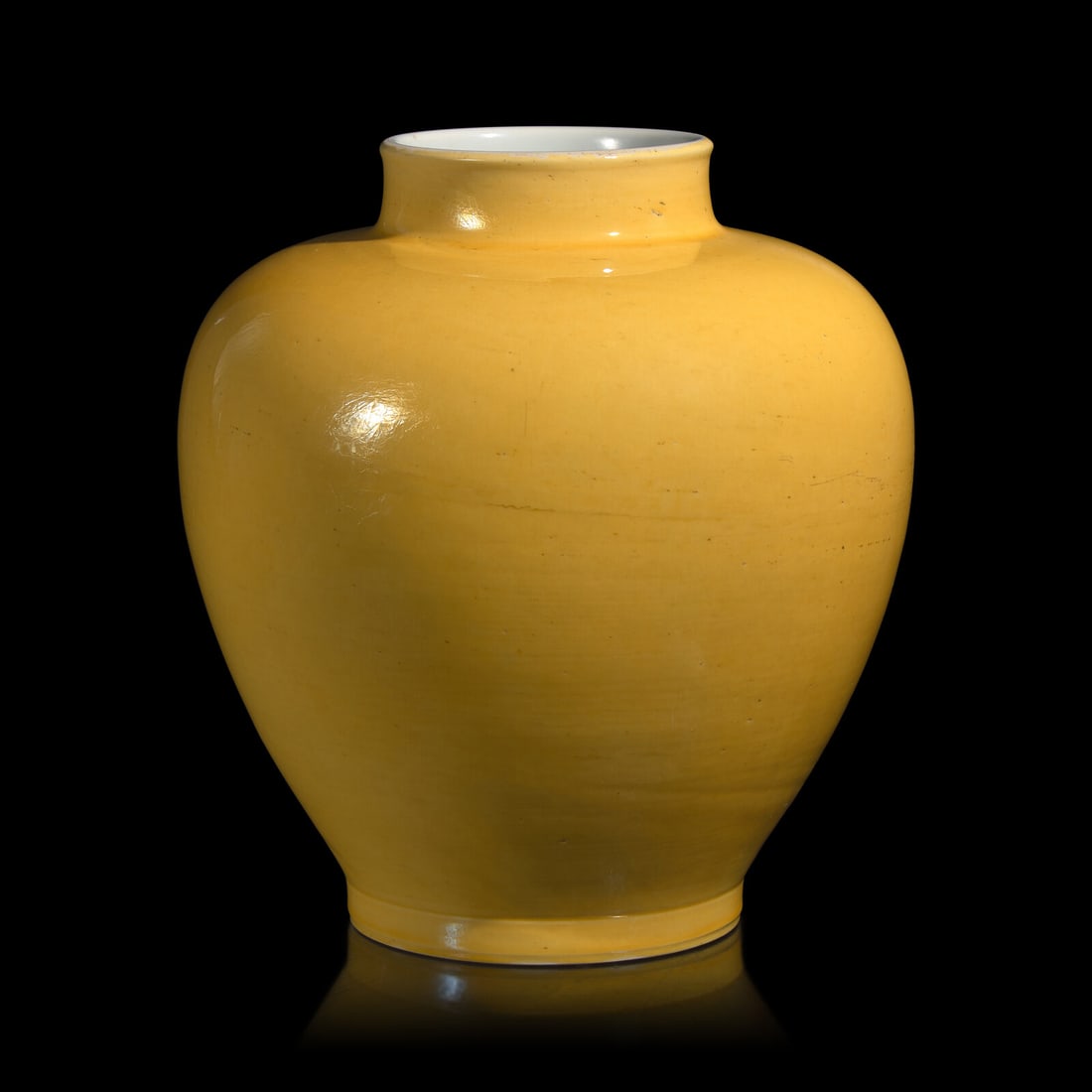 A Chinese Yellow Glazed Porcelain Jar, Qing Dynasty: A Chinese Yellow Glazed Porcelain Jar, Qing Dynasty 清 黃釉大罐 Qing Dynasty (1644-1911) The broad-shouldered body tapering to a short straight foot, the straight neck wi