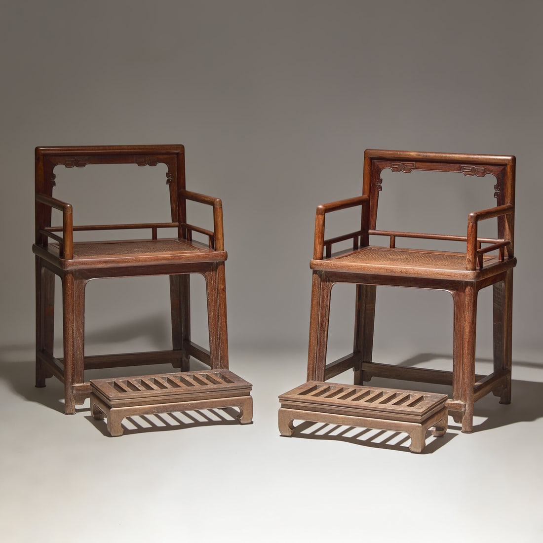 A Pair of Chinese Huanghuali Armchairs and Footrests, Meiguiyi, Early-Mid 20th Century: A Pair of Chinese Huanghuali Armchairs and Footrests, Meiguiyi, Early-Mid 20th Century 近代 黃花梨玫瑰椅及脚踏一套 Early-M
