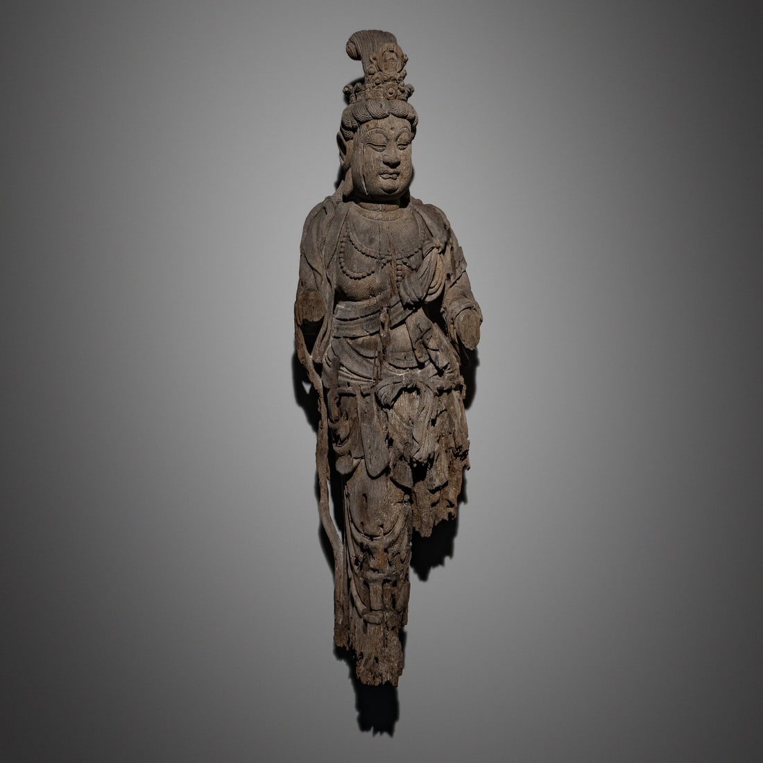 A Chinese Wood Carving of Guanyin Bodhisattva, Yuan Dynasty or Later: A Chinese Wood Carving of Guanyin Bodhisattva, Yuan Dynasty or Later 元或以後 木雕觀音像 Yuan Dynasty or Later The bodhisattva depicted wearing dr