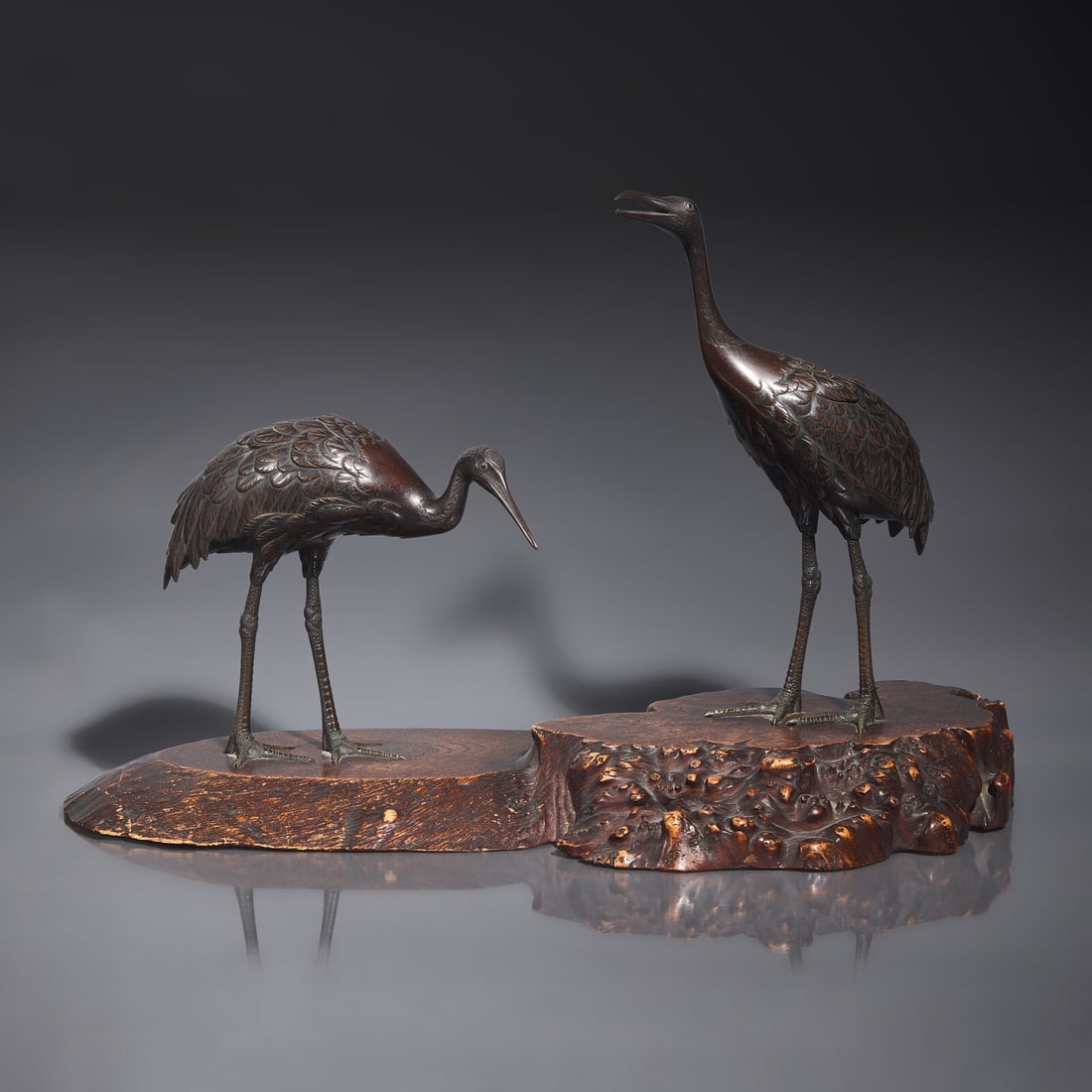 A Japanese Patinated Bronze 'Cranes' Figural Group, Hidenao, Meiji Period: A Japanese Patinated Bronze 'Cranes' Figural Group, Hidenao, Meiji Period 日本明治時代 銅鶴一對 Meiji Period (1868-1912) Depicting a pair of