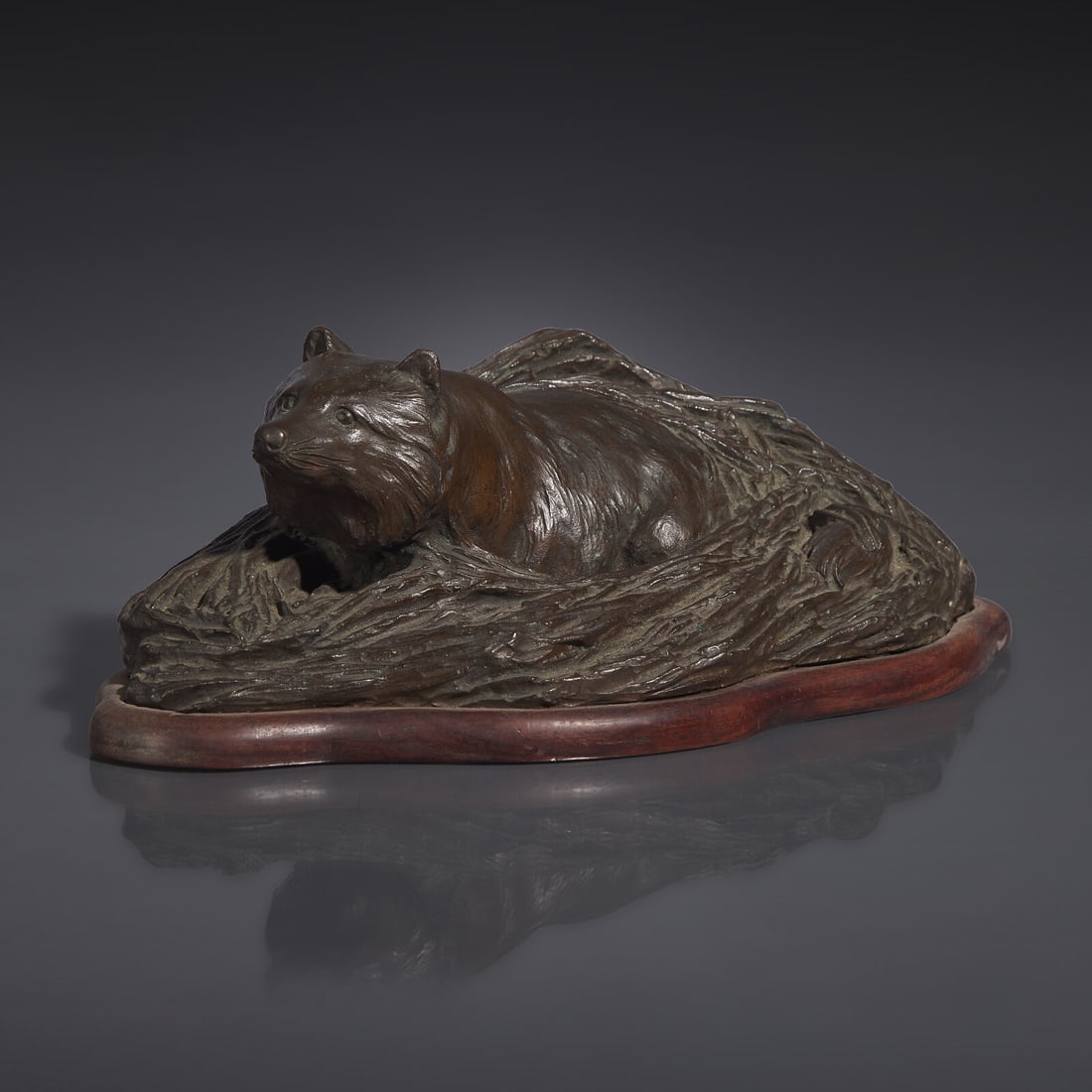 A Japanese Patinated Bronze Figure of a Tanuki in Grasses, Meiji/Taisho Period, The Maruki Co., (1 of 5)