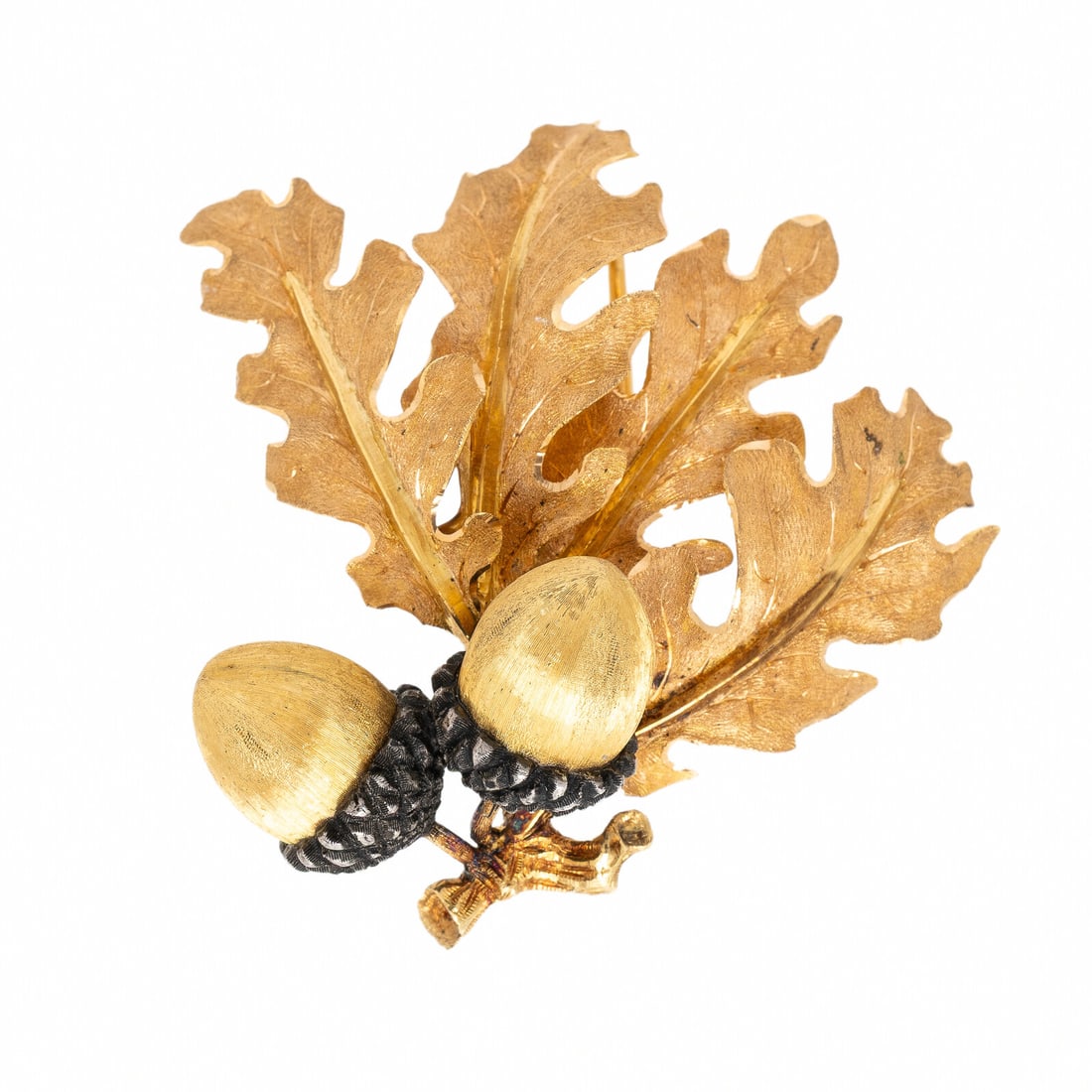 Buccellati, Bicolor Gold and Silver Acorn Brooch: Buccellati, Bicolor Gold and Silver Acorn Brooch Designed as oak leaves and acorns, with engraved texture. Mounted in silver and in 18 karat rose and yellow gold. 1 3/4 x 2 inches. Engraved: Buccellat