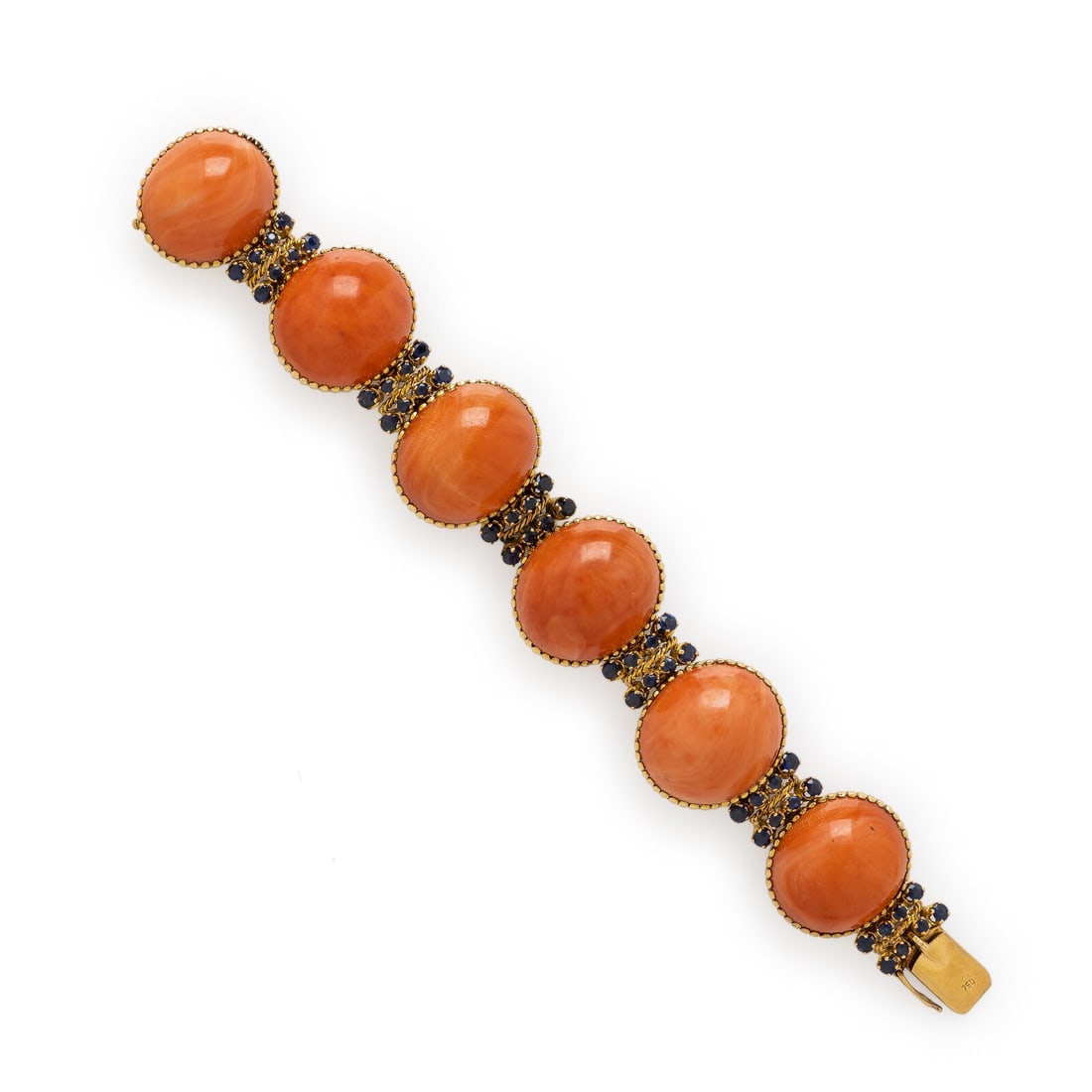 Coral, Sapphire, and Yellow Gold Bracelet: Coral, Sapphire, and Yellow Gold Bracelet Featuring six oval cabochon coral measuring approximately 24.00 x 20.50 x 11.00 mm, separated by links set with round sapphires. Mounted in 18 karat yellow go