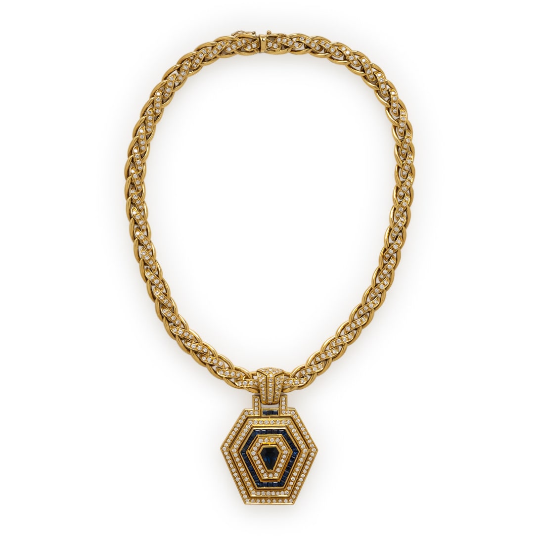 Yellow Gold, Diamond, and Sapphire Necklace: Yellow Gold, Diamond, and Sapphire Necklace Set with round brilliant cut diamonds weighing approximately 5.60 carats total, a shield sapphire, and calibré-cut sapphires. Mounted in 18 karat yellow go